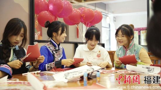 圖為少數民族學生包月餅共度中秋佳節。